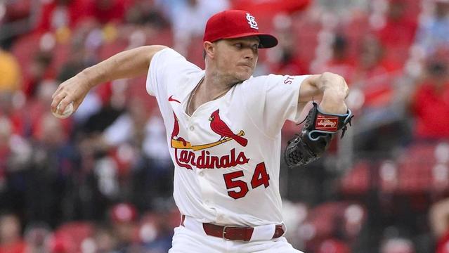 Cardinal starter Sonny Gray photographed in the middle of delivering a pitch while wearing St. Louis’ red-and-white home uniform.
