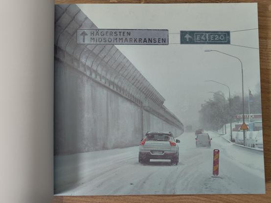 An illustration from "Swedish Machines: Sunset at Zero Point" by Simon Stålenhag showing a car on a snowy highway.