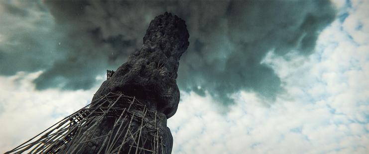 Wide shot, exterior, day -

A twisting stone spire reaching up to the clouds, standing on a small hill in a grassy plain.  Old ruins of platforms and scaffolding circle the base of the spire.