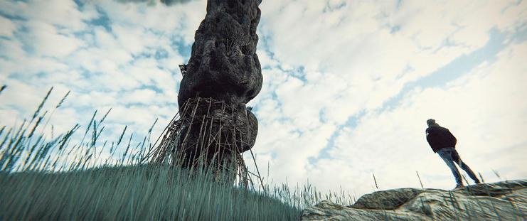 Wide shot, exterior, day -

A twisting stone spire reaching up to the clouds, standing on a small hill in a grassy plain.  Old ruins of platforms and scaffolding circle the base of the spire. A man in a jeans jacket is standing on a rock in the foreground, looking up.