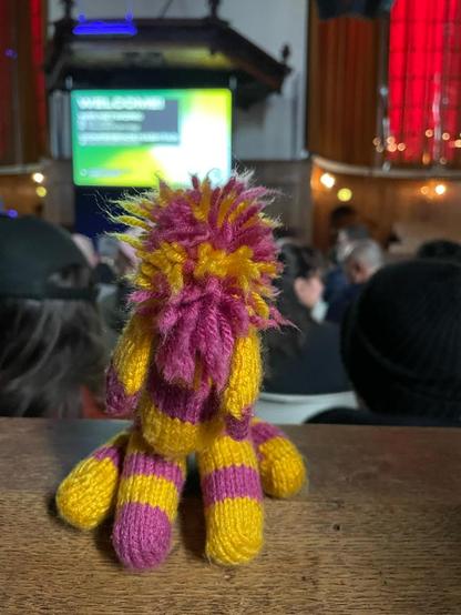 yellow and pink knitted zebra at fontstand conference in an old church