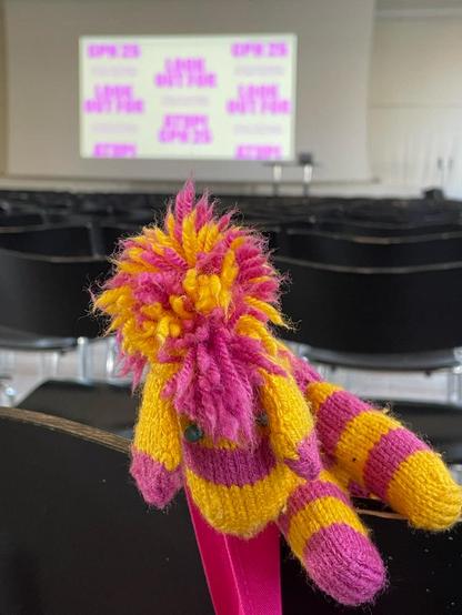 yellow and pink knitted zebra in an empty conference hall shortly before ATypI conference starts