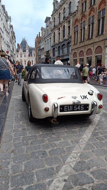 Rear of a cream white sixties British sports car
