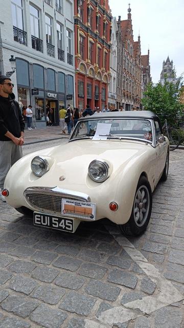 Front of the cream white Austin Healey Sprite with the distinctive bulging head lights
