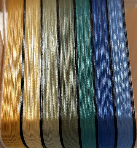 7 colours of warp threads in yellows, greens and blues with black threads between each colour