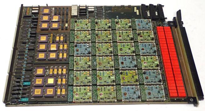 PCB stuffed with ceramic driver modules, red relays, and logic modules with square ICs