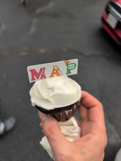 A cupcake with the MAP Family Learning Center logo on it.
