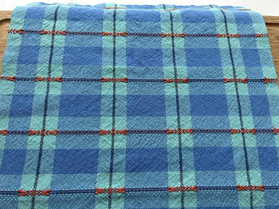Detail of handwoven blue checked teatowel after wet finishing