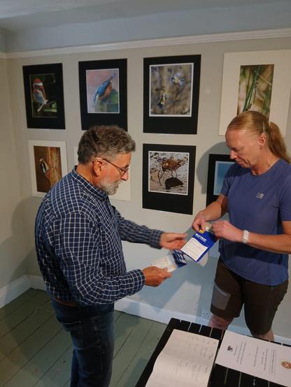 Members of the Royal Wootton Bassett Camera Club setting up an information area in their exhibition in the gallery of the Richard Jefferies Museum.