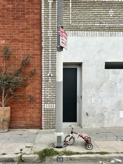 A tricycle chained to a light post 