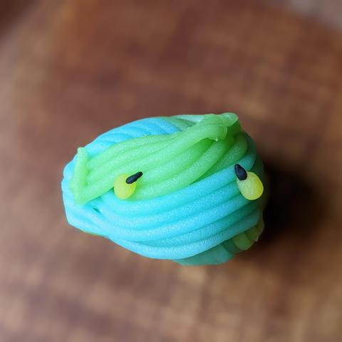 Tiny fireflies rendered in sweet form...the blue and green represents a river and riverbank.