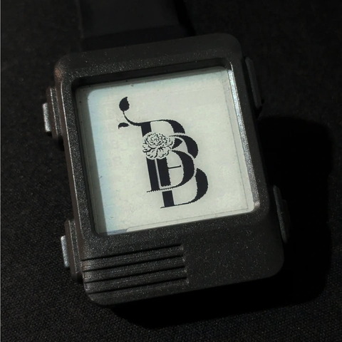 A monogram of two B's witha peony in the middle. Black on e-ink watch.