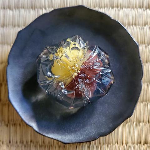 Hotaru-no-yoru, a jelly sweet wrapped around coloured bean paste. Small pieces of gold leaf mimic fireflies above water.