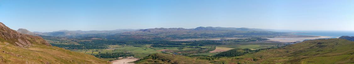 Panoramic view of Y Rhinogydd range, with the sands of the Dwyryd estuary visible at centre right and some of Moelwyn Bach at centre left.