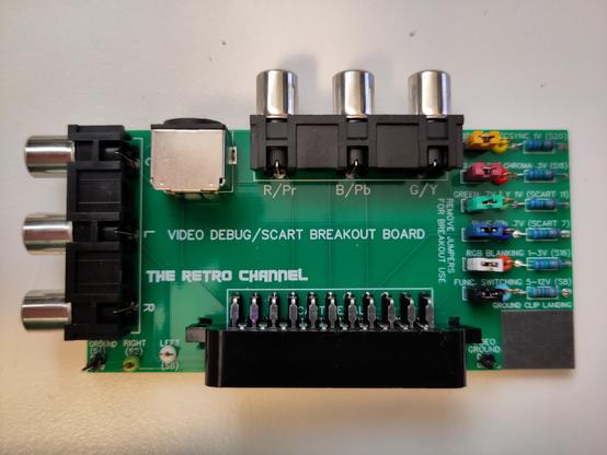 Closeup of the top side of the SCART breakout board. Various RCA, SVideo and other plugs on all sides, and a set of jumpers and hook points for oscilloscopes on the right.