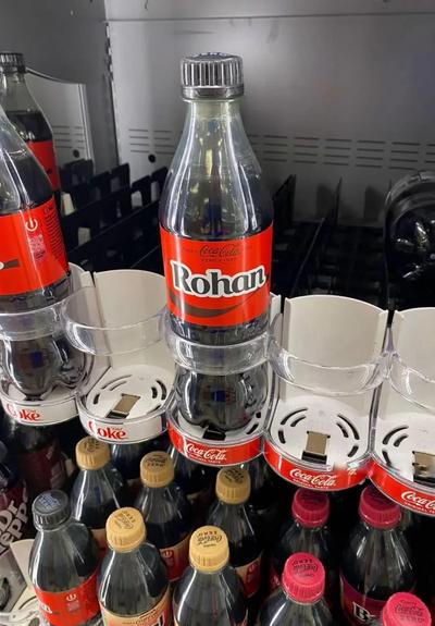 Coke bottle with the name Rohan on it, inside a vending machine