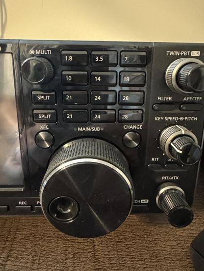 A closeup of the buttons and knobs on an amateur radio. The bottom row of buttons is a duplicate of the row above it and it shouldn't be.