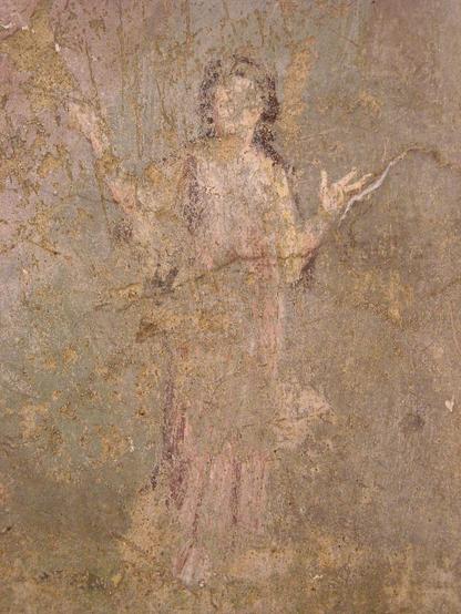 Roman fresco of Acca Larentia. She is wearing a long, pink dress and raises both hands as if speaking but most of the painting is sadly destroyed.