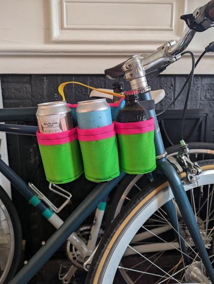 Two cans and a bottle inside of a top tube coozie-style holster.