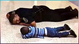 An Officer comforting a little boy by laying down to his level to chat