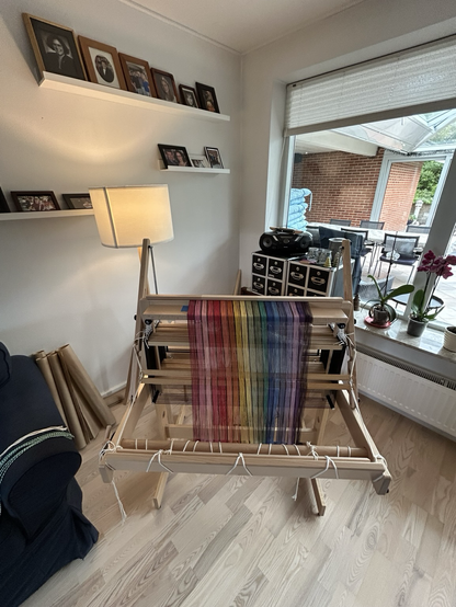 A rainbow warp laid out across the raddle of a hand loom - ready to wind on 