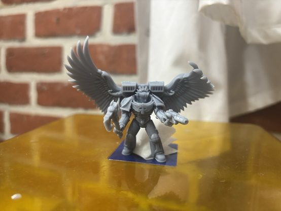 An old school dante with giant wings 3d printed in grey resin
