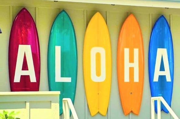Hawaiian "ALOHA" sign made out of different colored surfboards