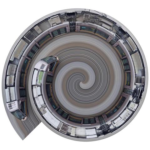 A slitscan photograph of a Dublin tram (Luas) taken from overhead. The full length of the tram has been wrapped into a spiral after the image was made.
