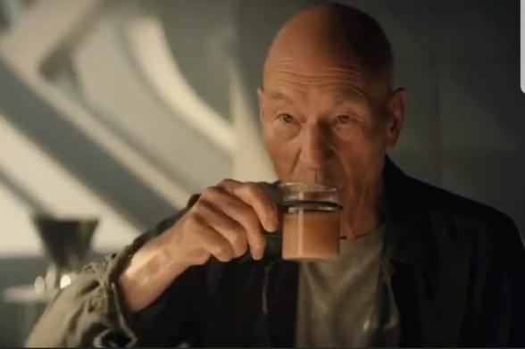 Star Trek Picard scene. And older Jean-Luc Picard, out of uniform, sips some tea.  (he's still wearing clothes, tho) No caption. 