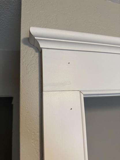 The finished corner assembly that includes a rounded cap and cove crown with beaded moldings.