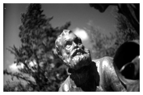 Closeup of a bronze statue beside the Näsikallio fountain, Tampere, depicting a "father"-figure. Sculpted by Emil Wikström 1913.