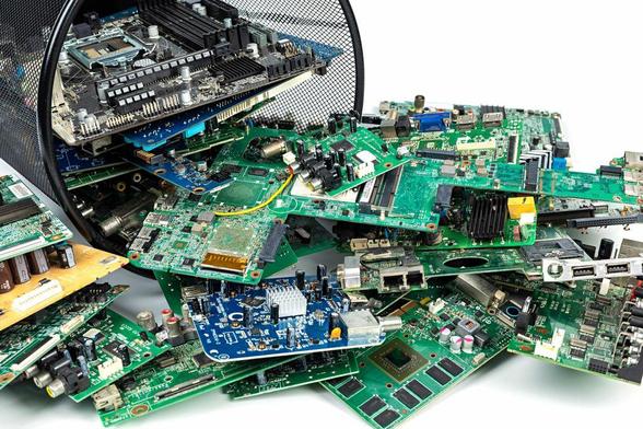 A waste bin tipped over, spilling out electronic circuits