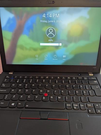 A Lenovo Thinkpad X280 showing the Fedora 42 login screen.