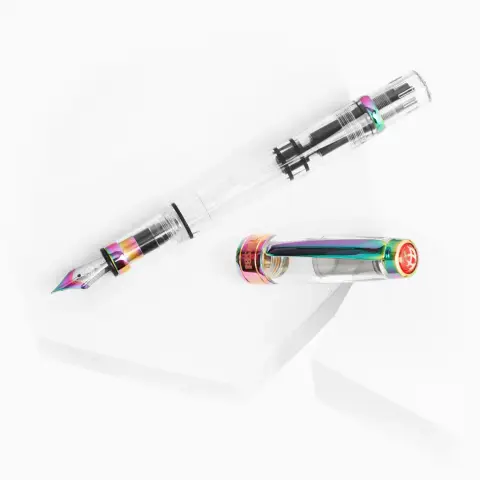 Product image of the TWSBI Diamond 580 IRIS showing the clear demonstrator pen and unposted cap with metal components finished in a "rainbow" style.