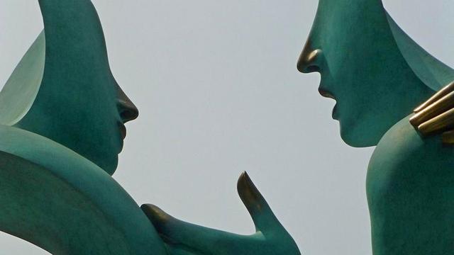 Statue of person talking to someone.