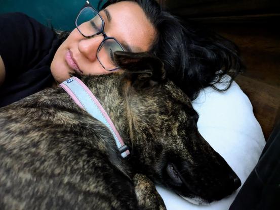 Persian woman cuddling dog
