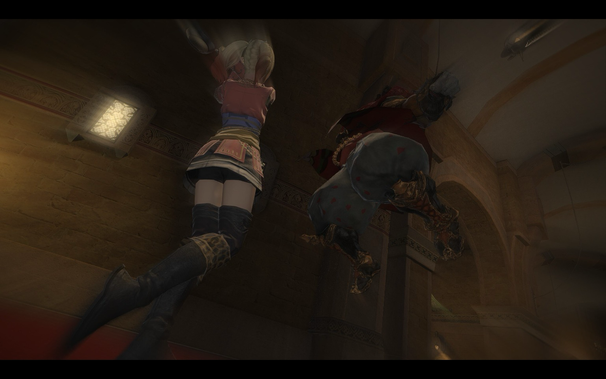 From a low angle, a woman leaps upwards, seemingly assisted by a character hanging from the ceiling. The woman, facing away, has bright hair and wears a short skirt with dark leggings. The hanging figure is partially obscured, wearing red and grey clothing with red heart patterns. A vintage-style building interior is visible in the background, dimly lit with architectural details and wall fixtures.
