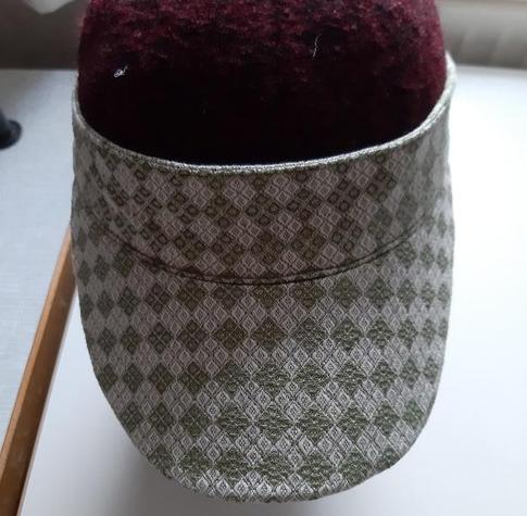 Sun Visor in a white/green diamond patterned fabric on a headform.