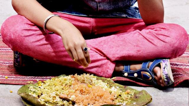 Lap of person sitting cross-legged eating.