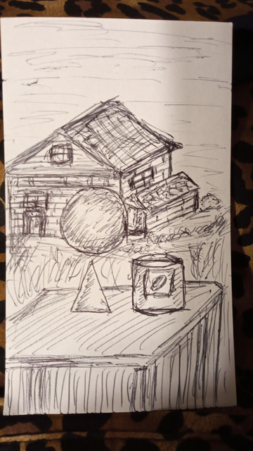 A 3x5 index card with a sketch in black ink on it. A table with a cone and a can of something on it in the foreground. A large, very spherical boulder in the midground. A farmhouse or barn with an attached shed in the background. 