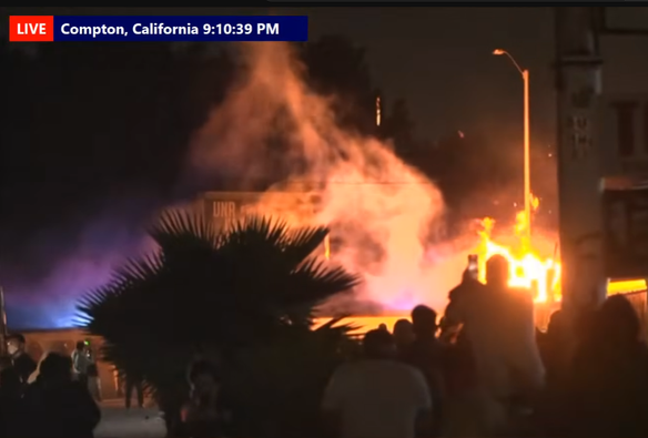 LIVE: Compton, California 9:10:39 PM

Yellow flames shoot up in the distance as a crowd is silhouetted by the light