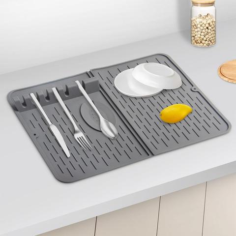 Terrible AI image of dish drying mat with unmatched proportions, misshapen silverware, unreal reflections, a bendy long orange(?), and a jar of giant glowing peppercorns