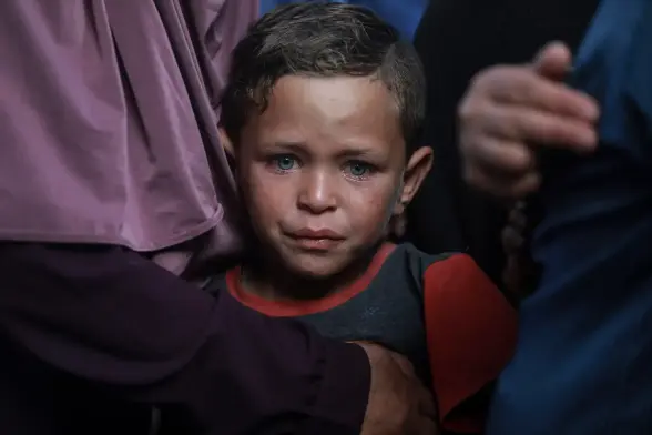A child cries during a funeral ceremony for Palestinians killed after Israeli forces carried out airstrikes.
