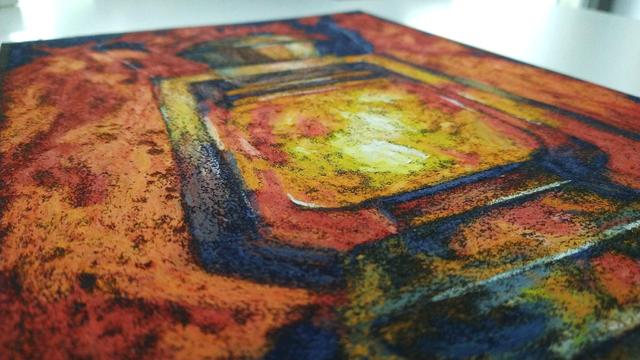 Close up of the same picture from another angle. You see the oil pastel being layered on top of each other. 