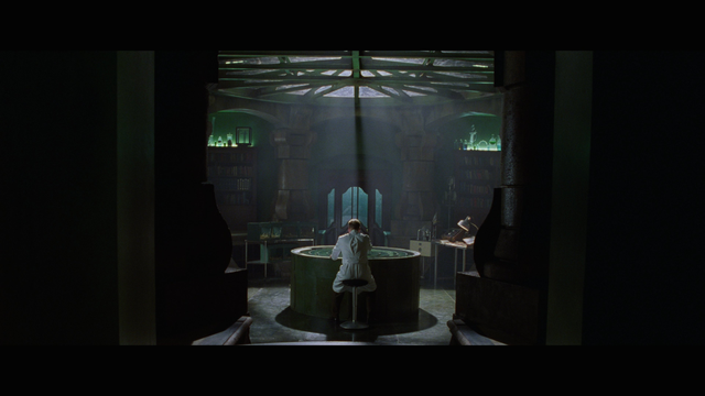 A laboratory with Kiefer Sutherland from behind in Dark City (1998, Alex Proyas)
