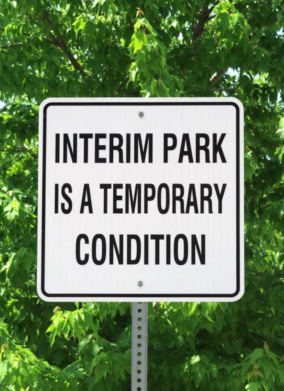A sign reads "Interim Park is a Temporary Condition," highlighting the park's provisional nature.