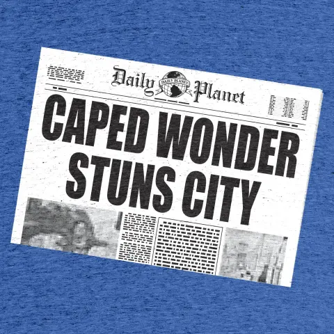 Shirt with a copy of the Daily Planet. The headline reads "Caped Wonder Stuns City."