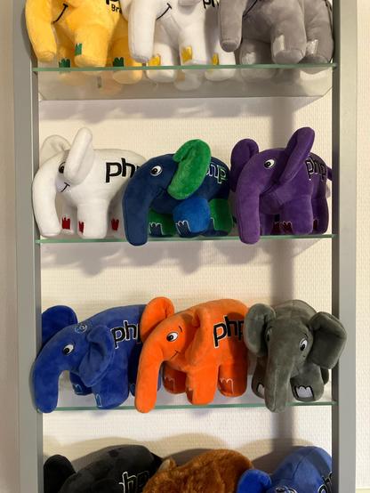 A number of pluche PHP elephants on a shelf