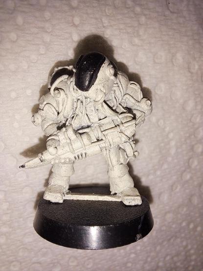 One of the first Space Marine figures Games Workshop ever made. He is wearing power armour that has a lot of exposed cables, and probably isn't very safe. He holds a large gun, with a blade attached like a bayonet. He has been undercoated white, and the large visor on his helmet has been painted black.