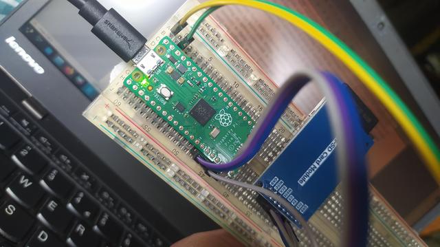 A breadboard with a Pico H and a SD card breakout and some wires. 
